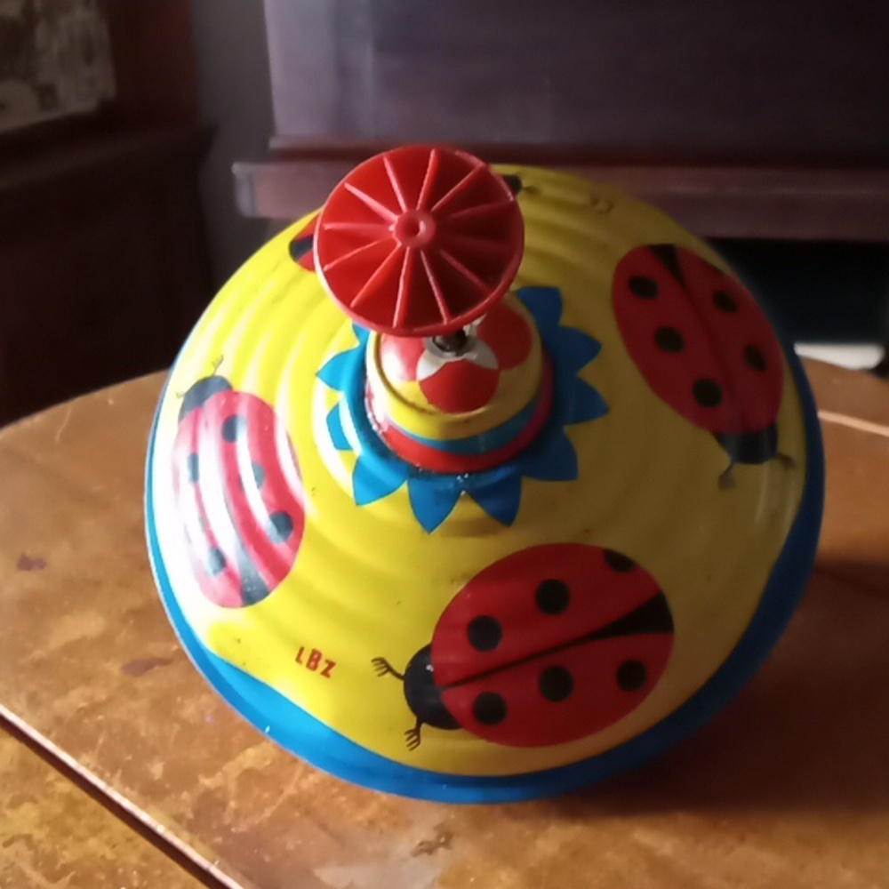 Vintage toy metal ladybug spinning top
